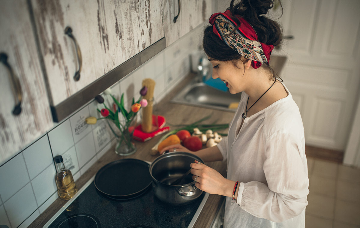 A girl prepares food in her kitchen 